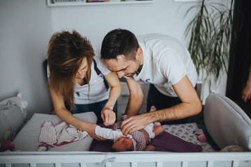Mother and father dress thei newborn baby