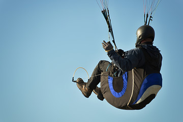 One paragliding in a beautiful blue sky