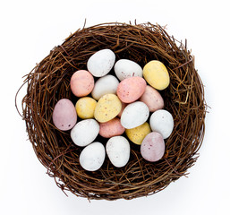 Easter basket nest with Easter candy eggs isolated 