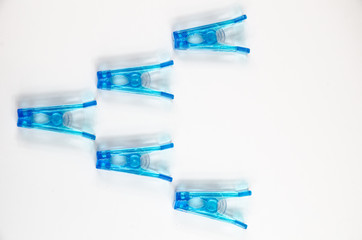 Blue clothes peg on white