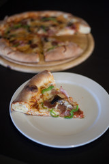 Slice of pizza on white dish