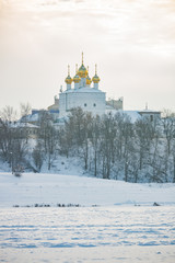 Fototapeta na wymiar Church in winter frozen river