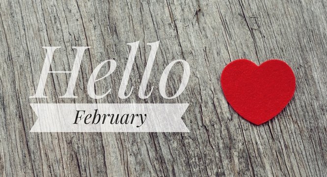 Hello February words on red heart and wooden background