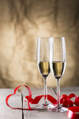 two champagne glasses with red ribbon heart shape .valentines da