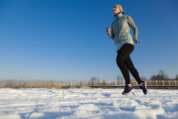 Jogging woman in winter with copy space