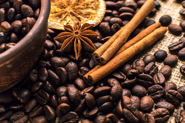 Coffee beans into bowl with cinnamon and anise