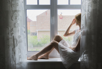 girl sitting on a window sill