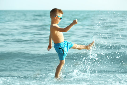 Cute boy having fun on beach