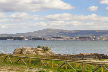 Fototapeta na wymiar Rocks and fence on the beach