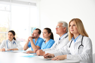 Fototapeta premium Team of doctors sitting at table in clinic