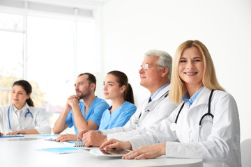 Fototapeta premium Team of doctors sitting at table in clinic