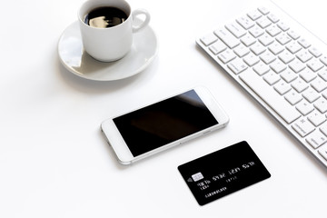 Obraz na płótnie Canvas credit card, keyboard, smartphone and coffee cup on white background