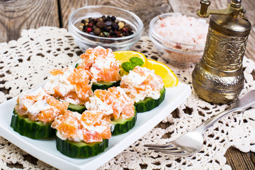 Appetizer with salmon, cucumber and goat cheese