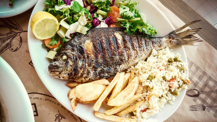 Bream with potato, rice and salad