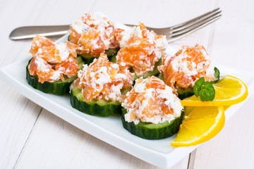 Appetizer with salmon, cucumber and goat cheese