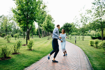 Fototapeta premium Groom and bride have fun at wedding day