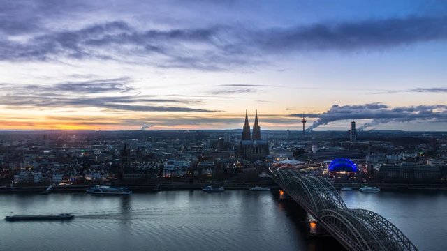 Beautiful sunset turning into blue hour above Cologne. Aerial view of the Cathedral - Dom and Hohenzollern bridge
