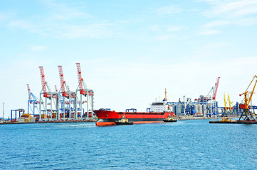 Naklejka premium Tugboat assisting bulk cargo ship