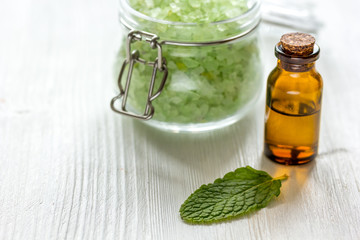 organic cosmetics with herbal extracts of mint on wooden background