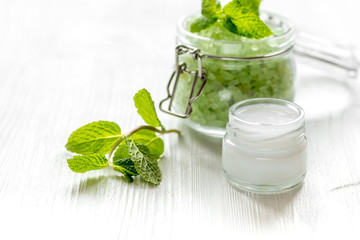 organic cosmetics with herbal extracts of mint on wooden background