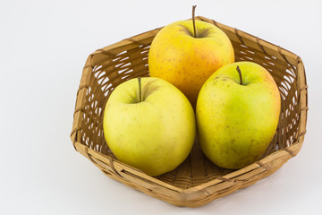 Fresh, Ripe apples in basket on white background.