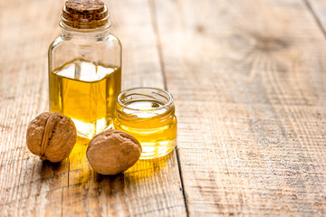 cosmetic and therapeutic walnut oil on wooden background