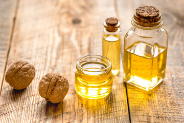 cosmetic and therapeutic walnut oil on wooden background