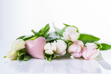 Pink tulips and heart on a white background