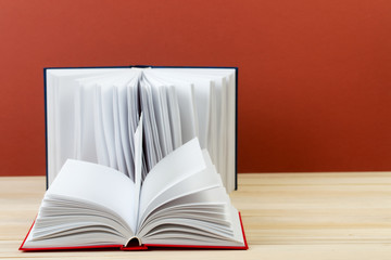 Open books on wooden table.