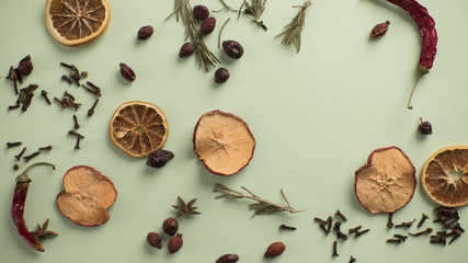 dry fruits and spices lie on a green background