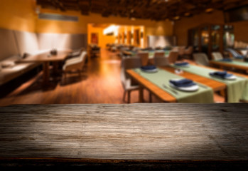 Empty wooden decktablecloth for product montage. Restaurant as background