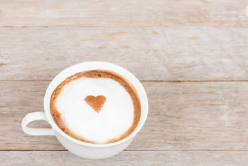 Latte coffee with the heart on frothy milk is ready to drink.  .