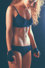 Portrait of young beautiful fitness woman, isolated on black background