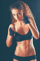Portrait of young beautiful fitness woman, isolated on black background