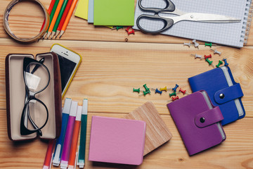 glasses in the case and office supplies on the desk, touch phone