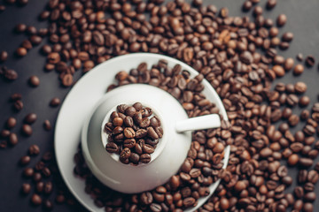 cup on saucer and coffee beans