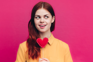 woman with a red heart and in a beautiful shirt