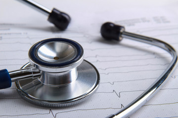 Stethoscope on electrocardiogram lying at the desk