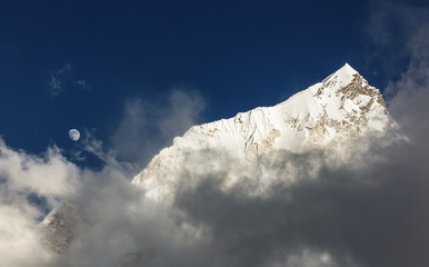 View of the Nuptse (7864 m) and full Moon from the slope of the Kala Patthar - Nepal, Himalayas