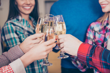 Hands of best friends holding glasses of champagne making a toas
