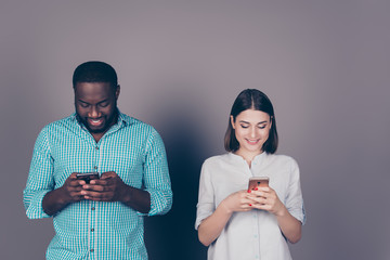 two mixed race people look at phone. Beautiful caucasian girl an