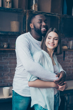 two cheerful mixed race people hugging.   Handsome afro american