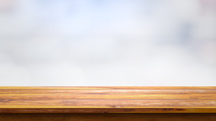 Empty wooden table with blur white background.