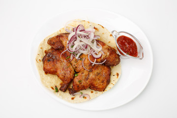 Naklejka premium Fried chicken on pita bread with red sauce on a white background