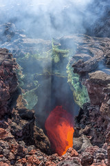 The boiling magma flows through lava tubes under a layer of cooled lava - volcano Tolbachik,...