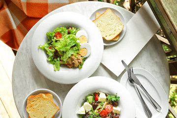 Breakfast with tasty salads on table in cafe