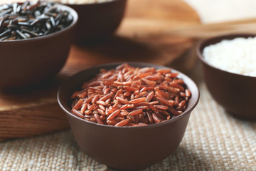 Different types of rice in small bowls closeup