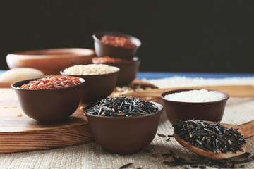 Different types of rice in small bowls closeup