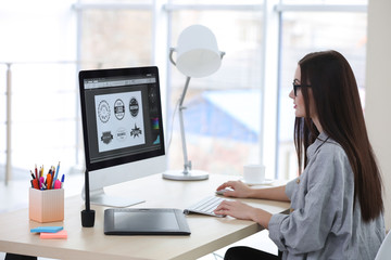 Young female designer working in office