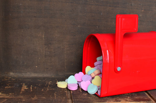 Candy Conversation Hearts Spilling Out Of A Red Mailbox 